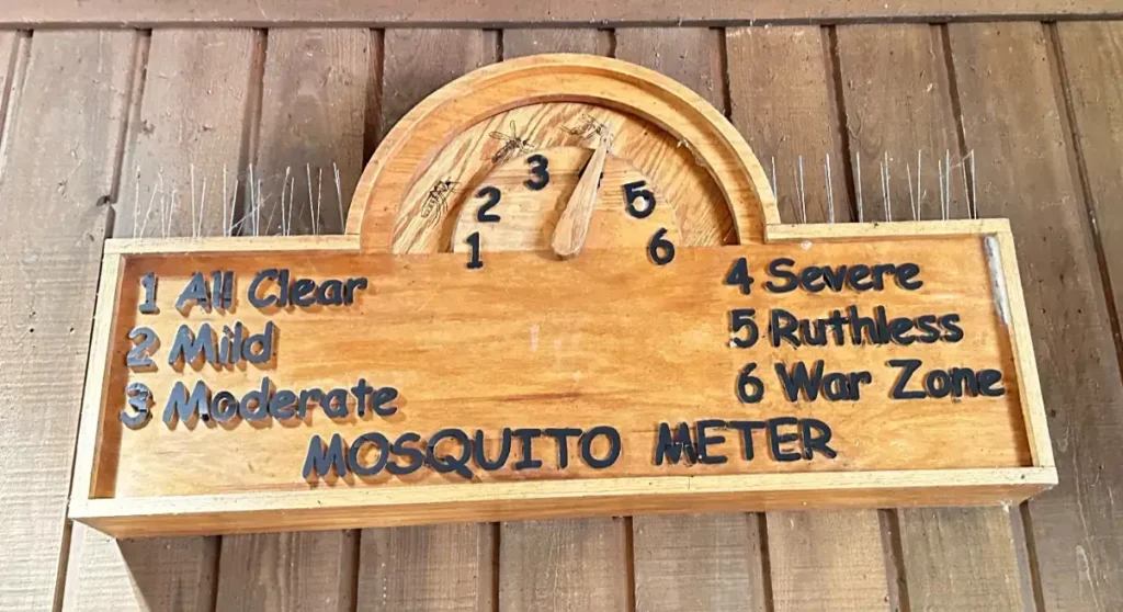 A wooden mosquito meter with numbers and text.